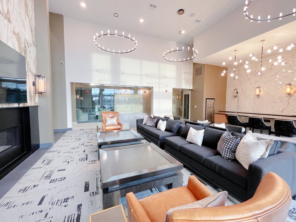 a living room with couches and a table and a fireplace