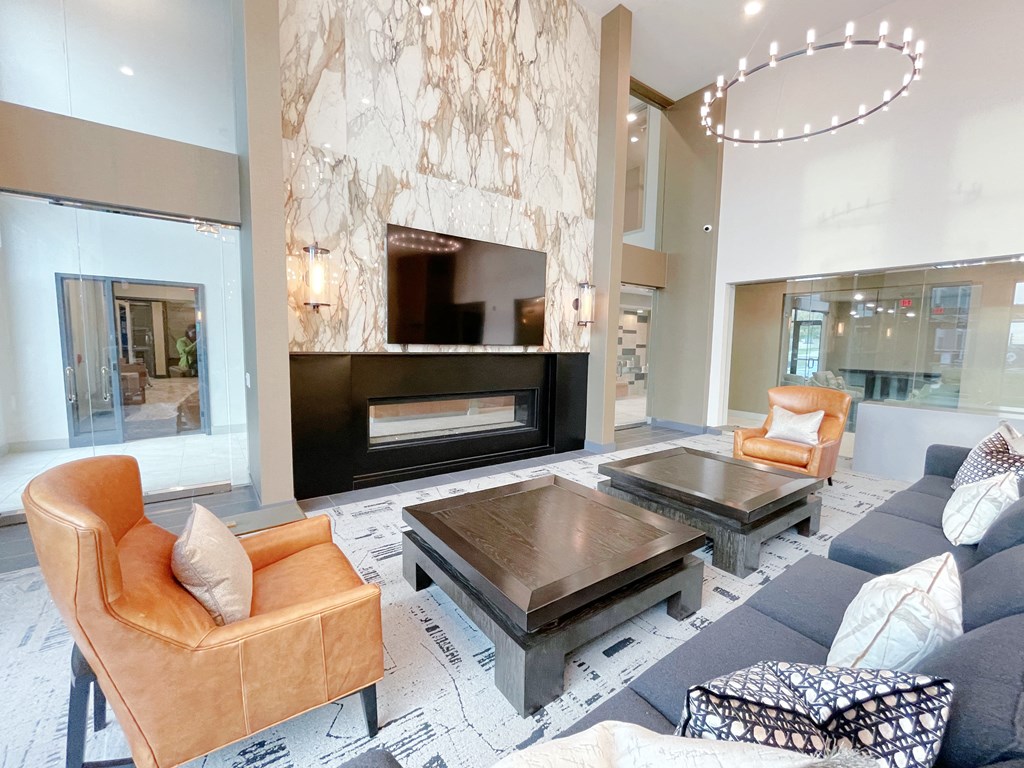 a living room with a blue couch and a fireplace