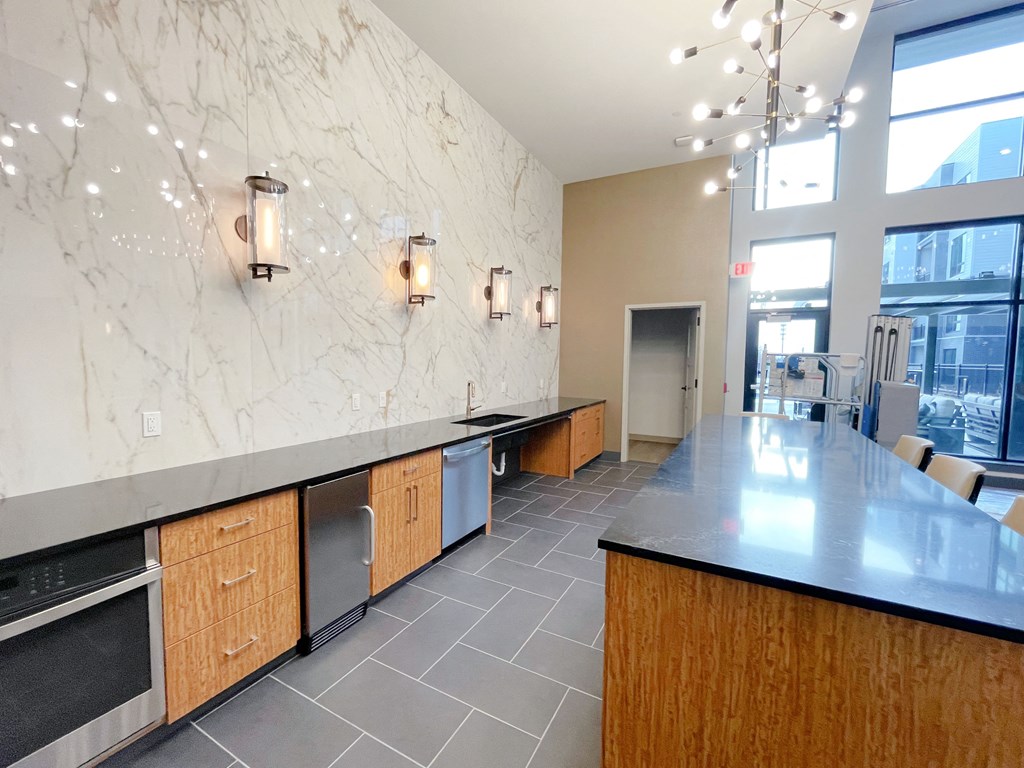 a kitchen with a long counter top and a large window