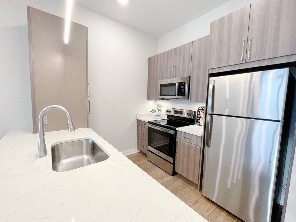 a kitchen with stainless steel appliances and a white counter top