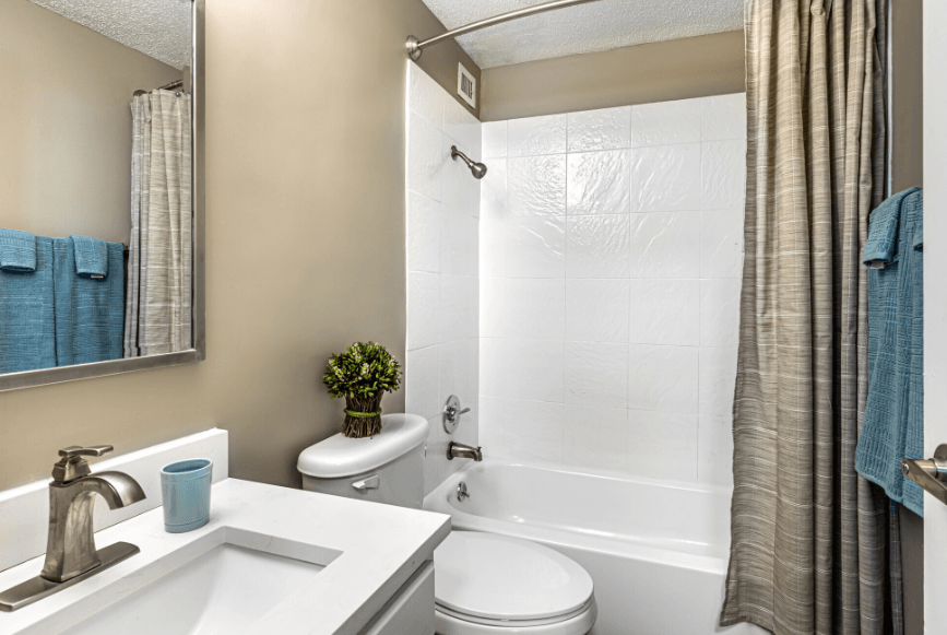 a bathroom with a toilet sink and tub and a shower