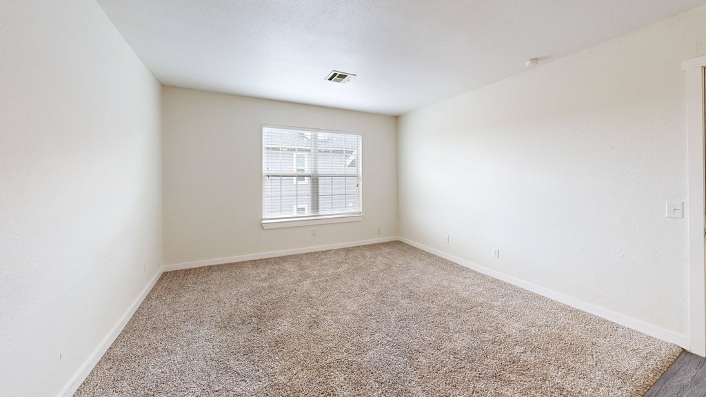 a bedroom with white walls and a window at Bennett Ridge Apartments, Oklahoma City, OK, 73132