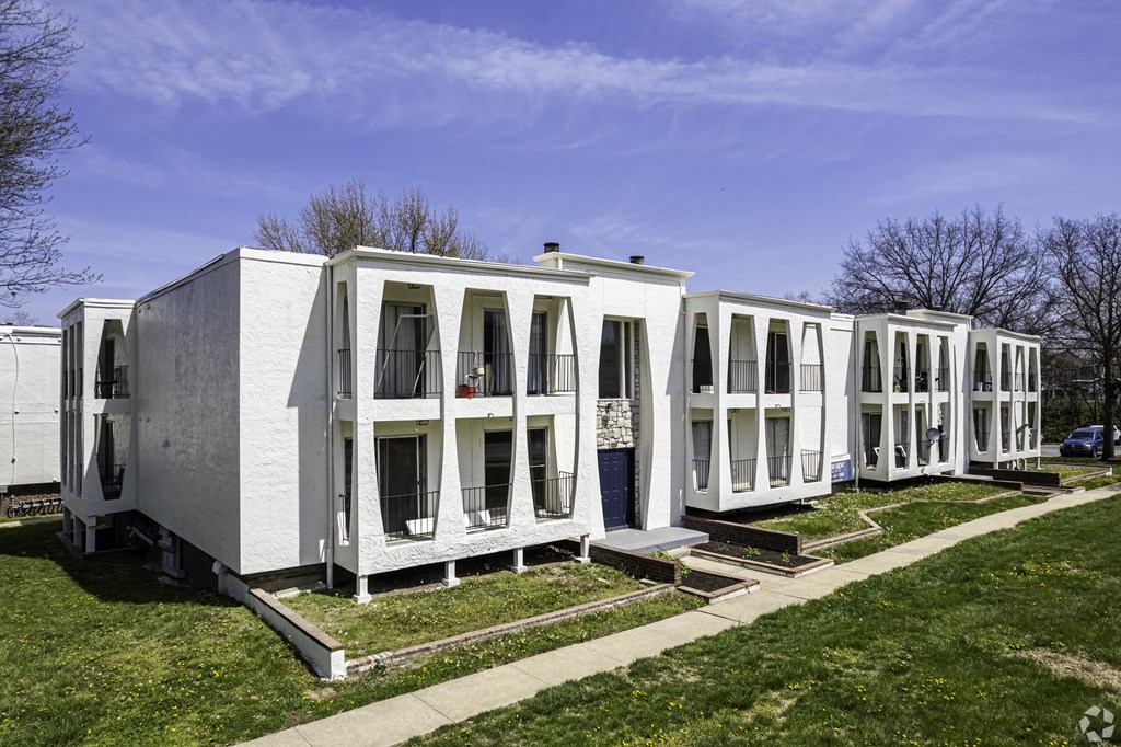 Photo of building exterior, white two story building.
