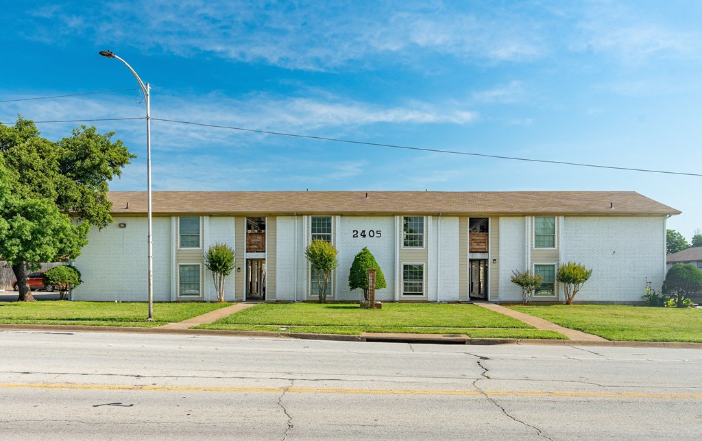 a white building with a street in front of it