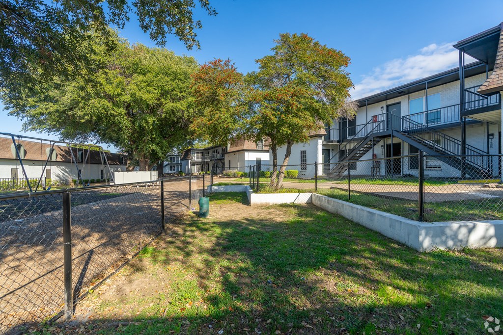 A sunny day at a residential area with houses and trees.