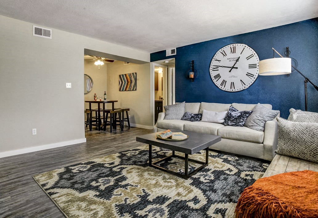 Image of living room with couch, coffee table, and view of dining room