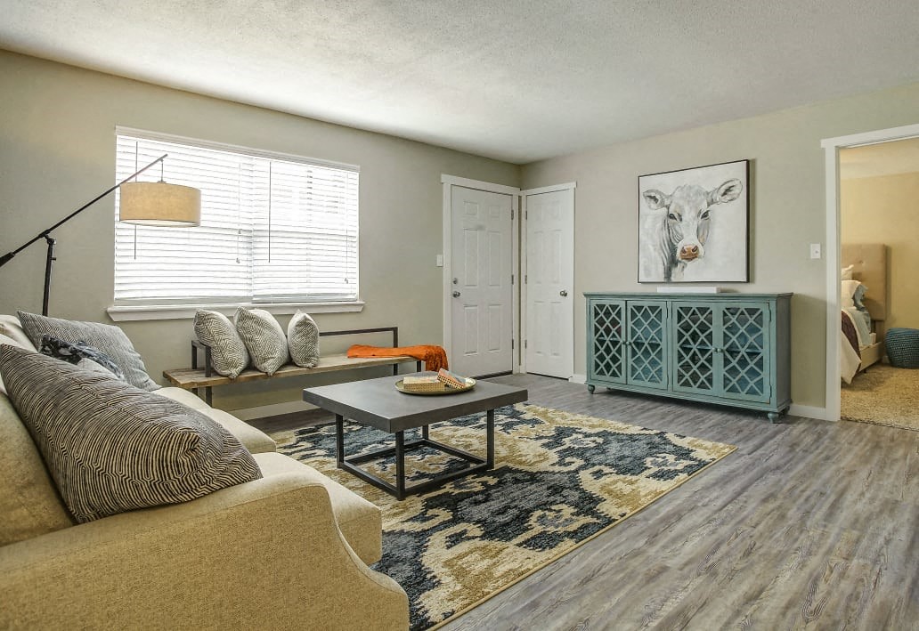 Image of renovated living room with couch, chair, and coffee table