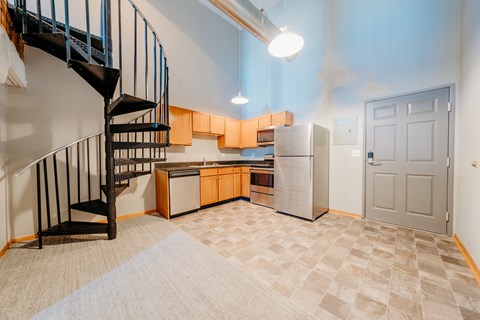 A kitchen with a refrigerator, sink, and stove is shown.