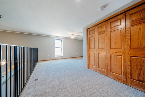 A room with a wooden door and a window.