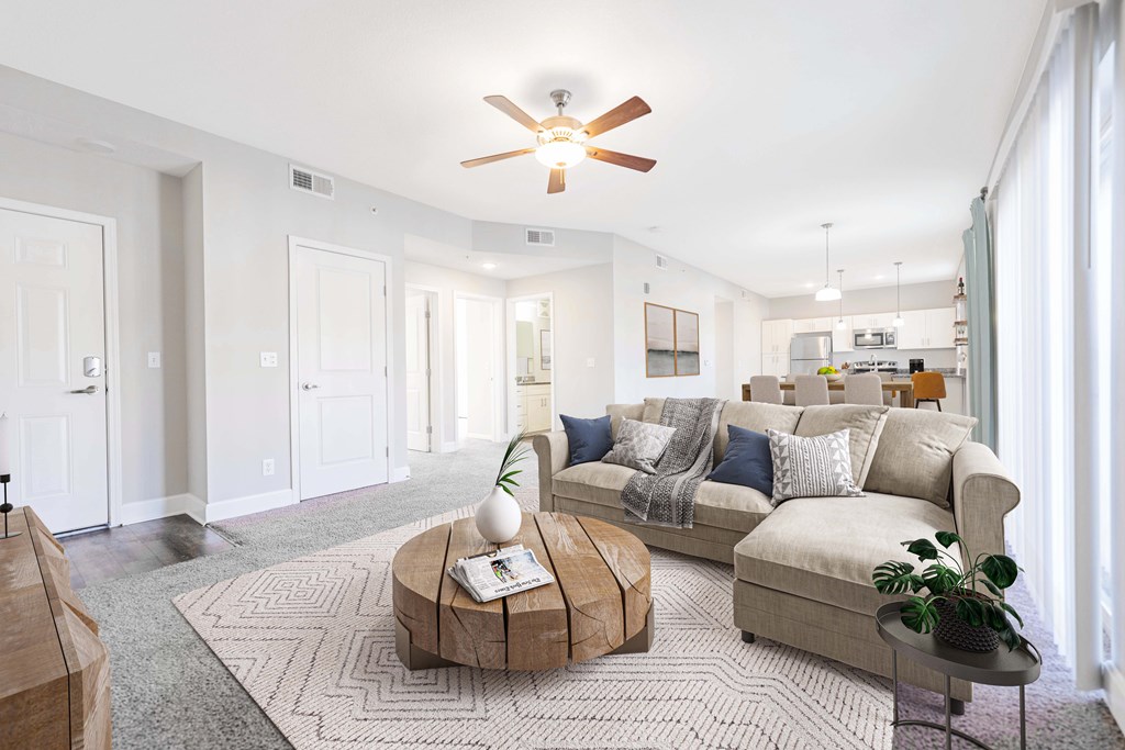 living room with coffee table sectional couch and ceiling fan