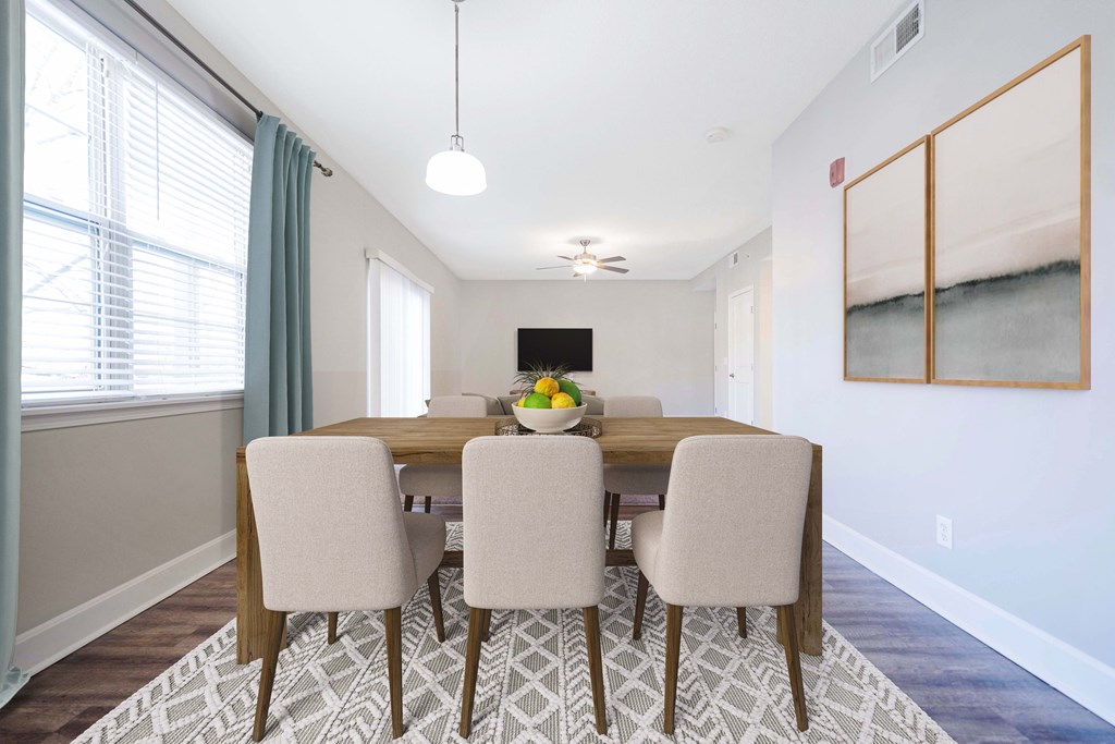A dining room with a table and chairs.