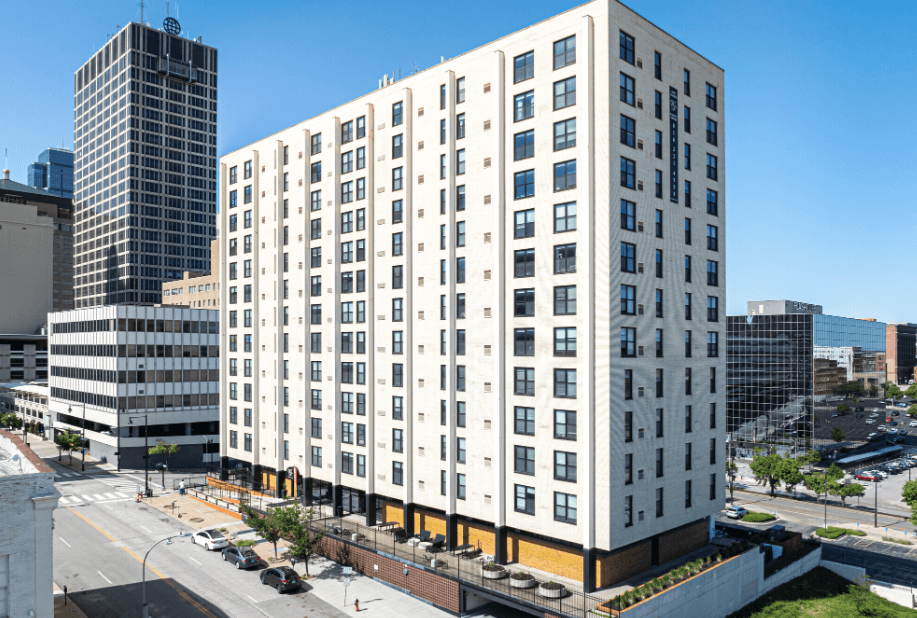 an aerial view of a tall white building in a city