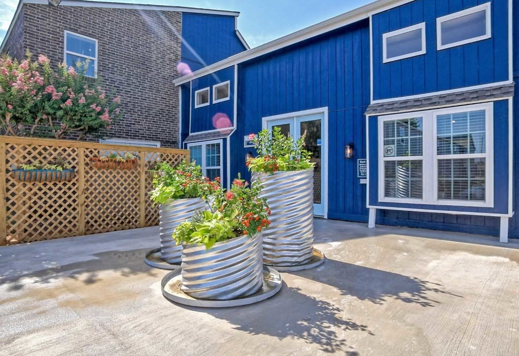 Exterior image of clubhouse with flower planters and fencing  at Residences at Lakeshore Apartments, Oklahoma City, Oklahoma