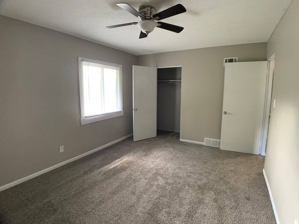 large bedroom with closet and ceiling fan