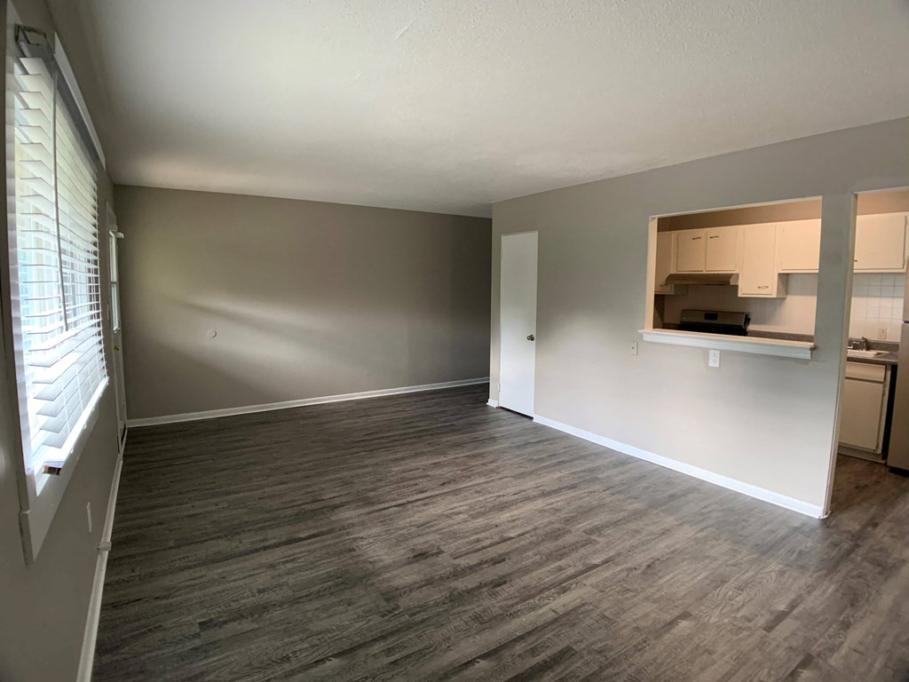 large living room with vinyl plank flooring and breakfast bar