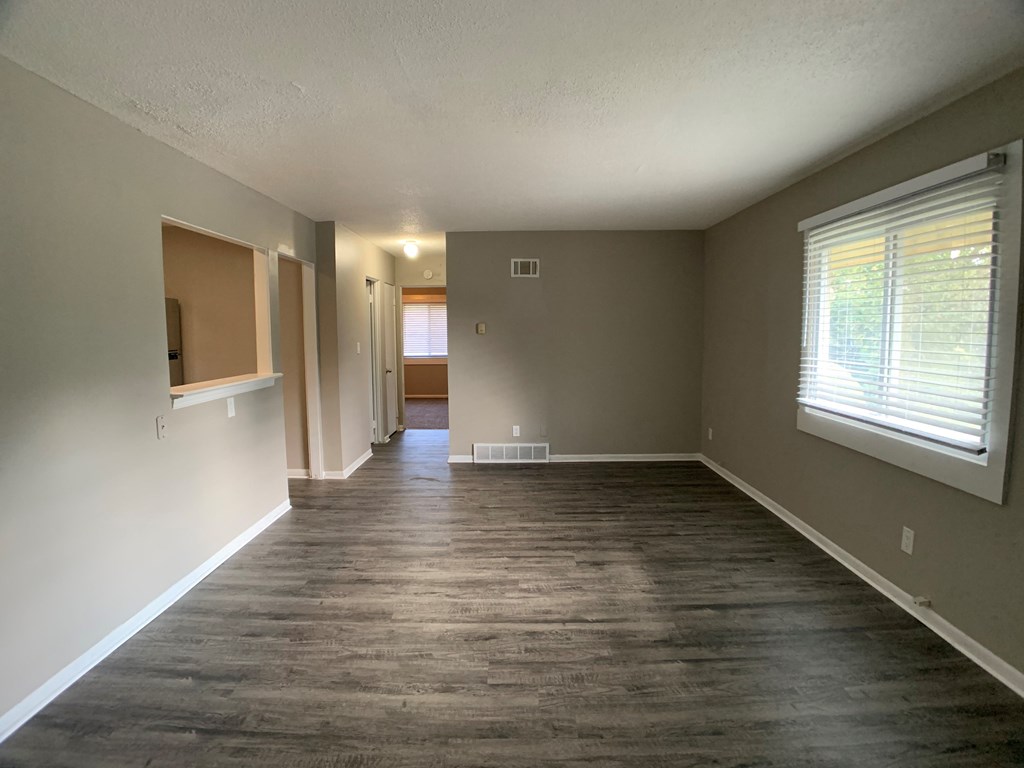 large living room with vinyl plank flooring and breakfast bar