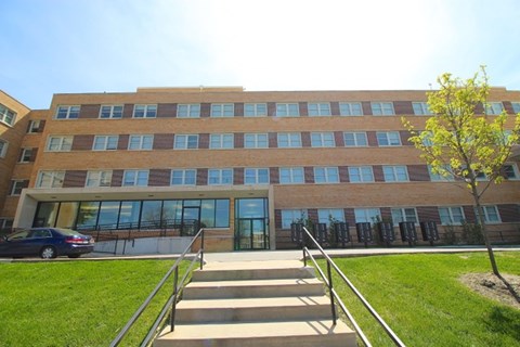 A large building with a tree in front of it.