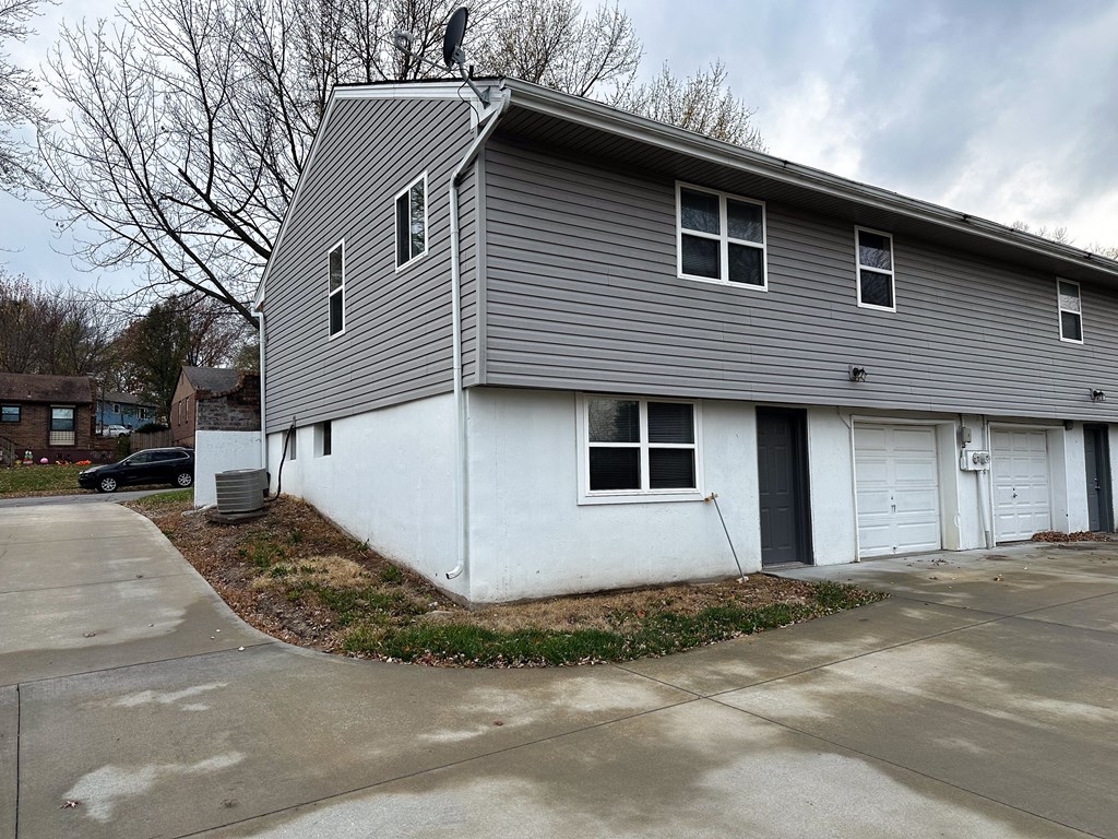 a white and gray house with a white garage