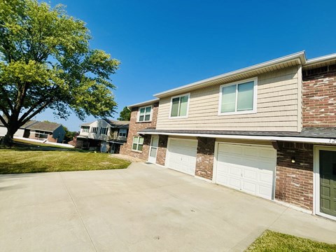 A residential building with a tree in front of it.