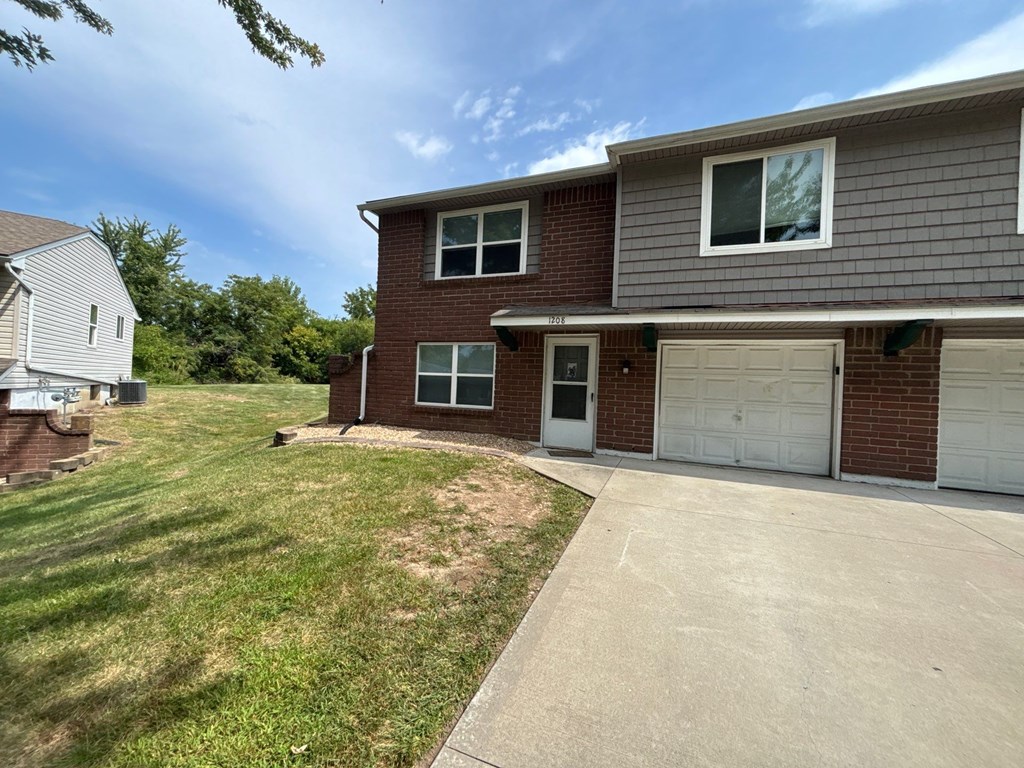 A house with a garage and a driveway.