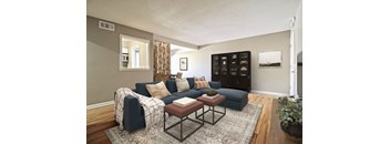 A living room with a dark blue couch and a coffee table.