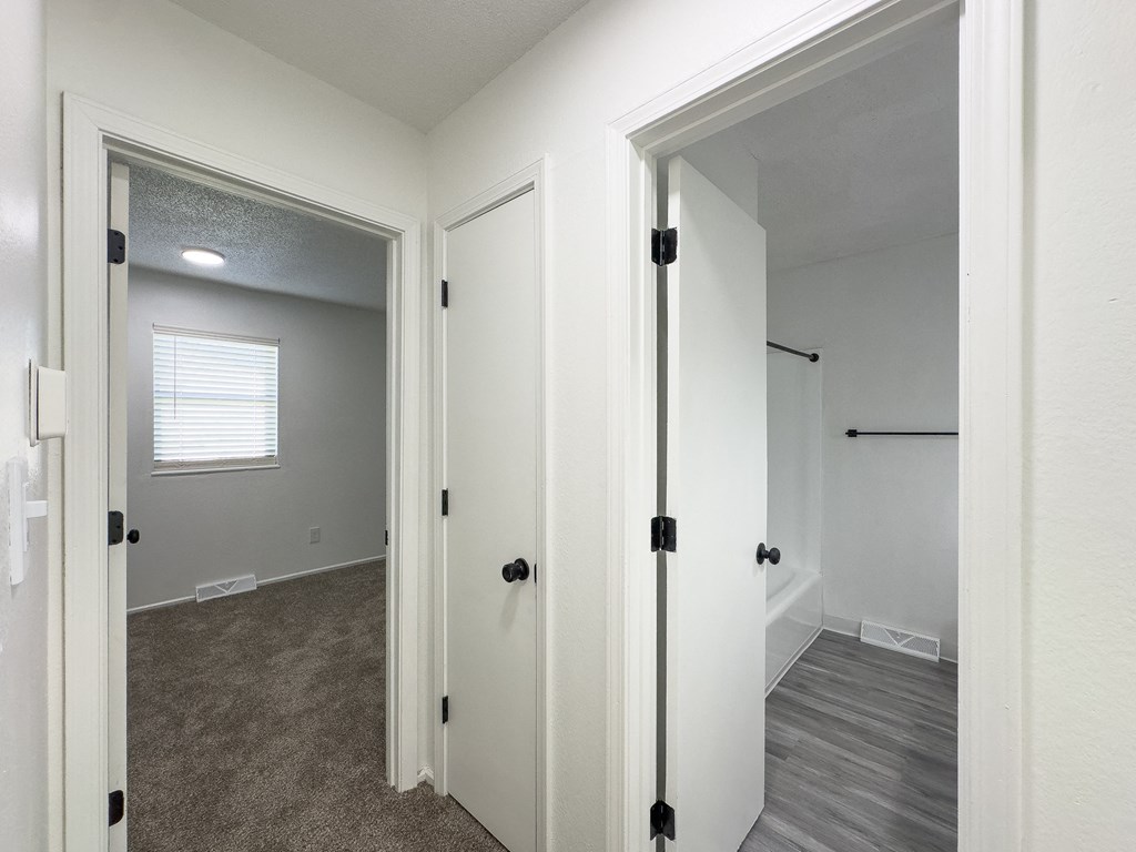 a bedroom with a closet and a door to a bathroom
