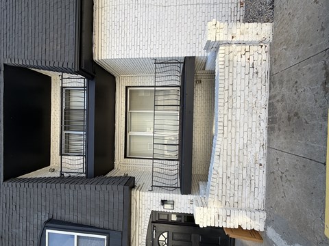 A building with a black and white tiled exterior.