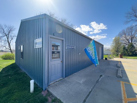 a small building with a flag in front of it next to Northwest Missouri State University