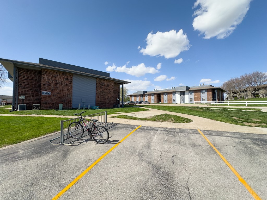 a bike parked in a parking lot in front of a building