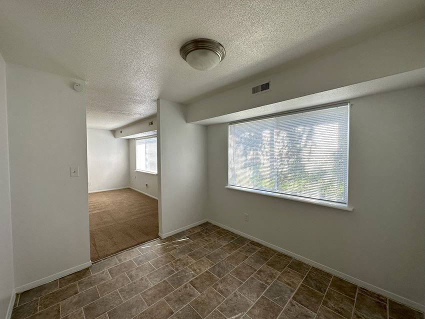 a bedroom with a large window and a tiled floor - Photo Gallery