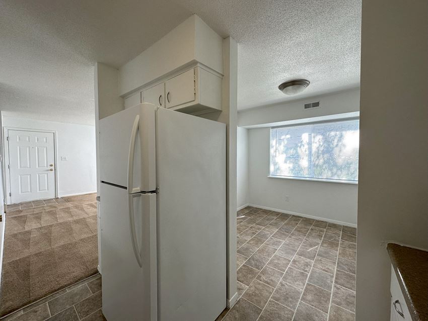 a kitchen with a refrigerator and a window - Photo Gallery