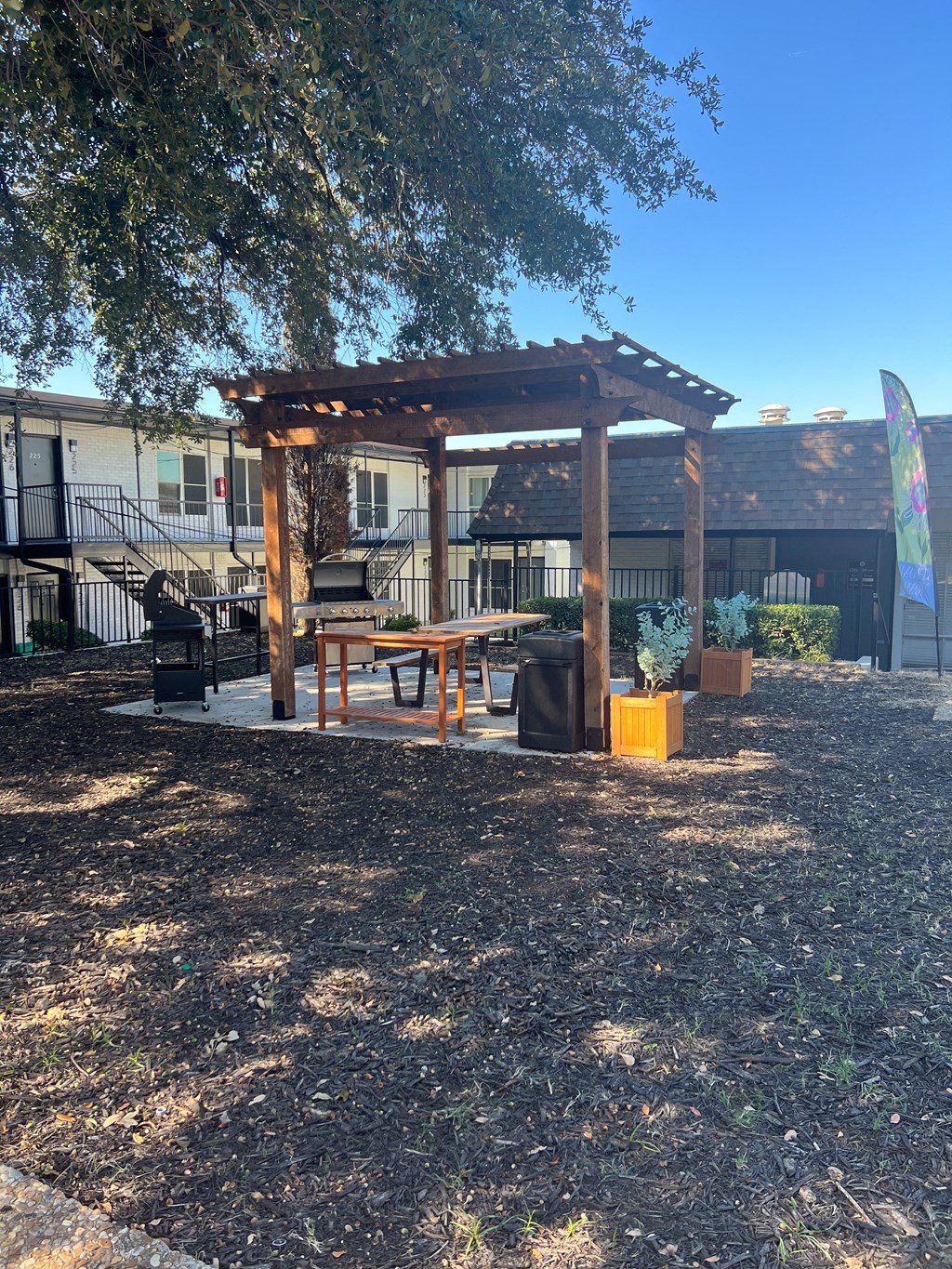 a patio with a picnic table and a pergola