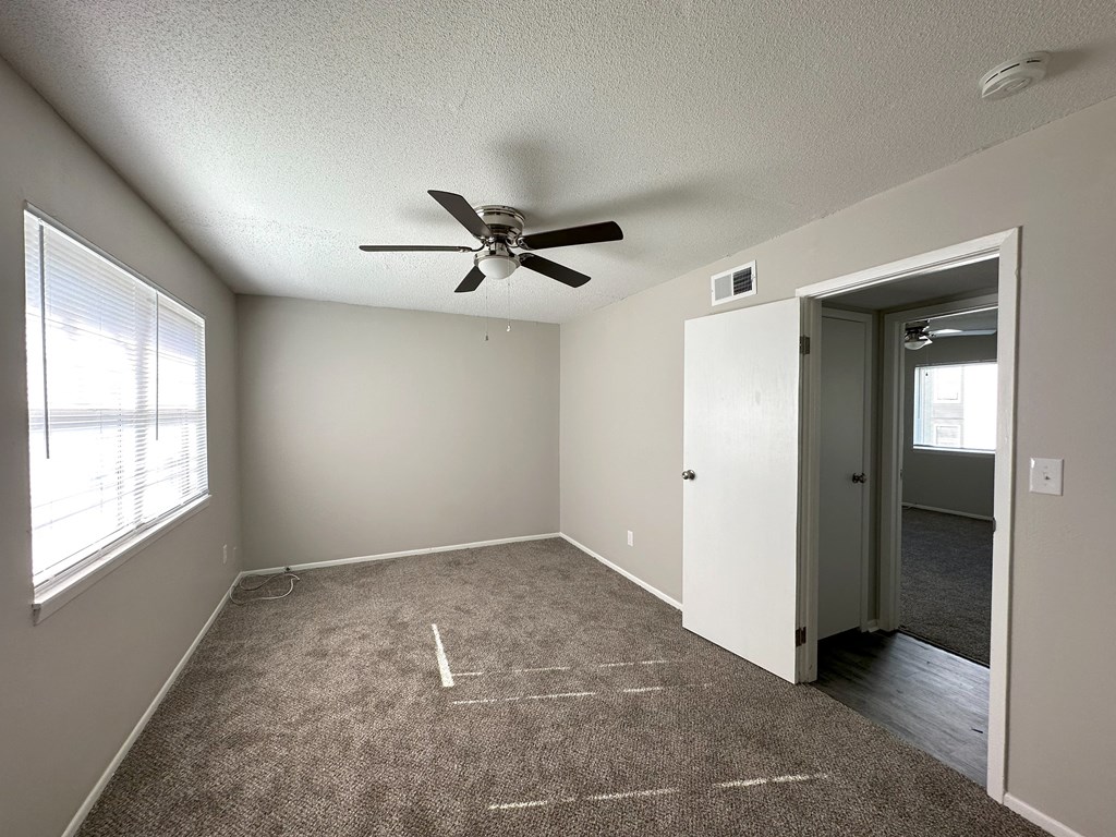 an empty room with a ceiling fan