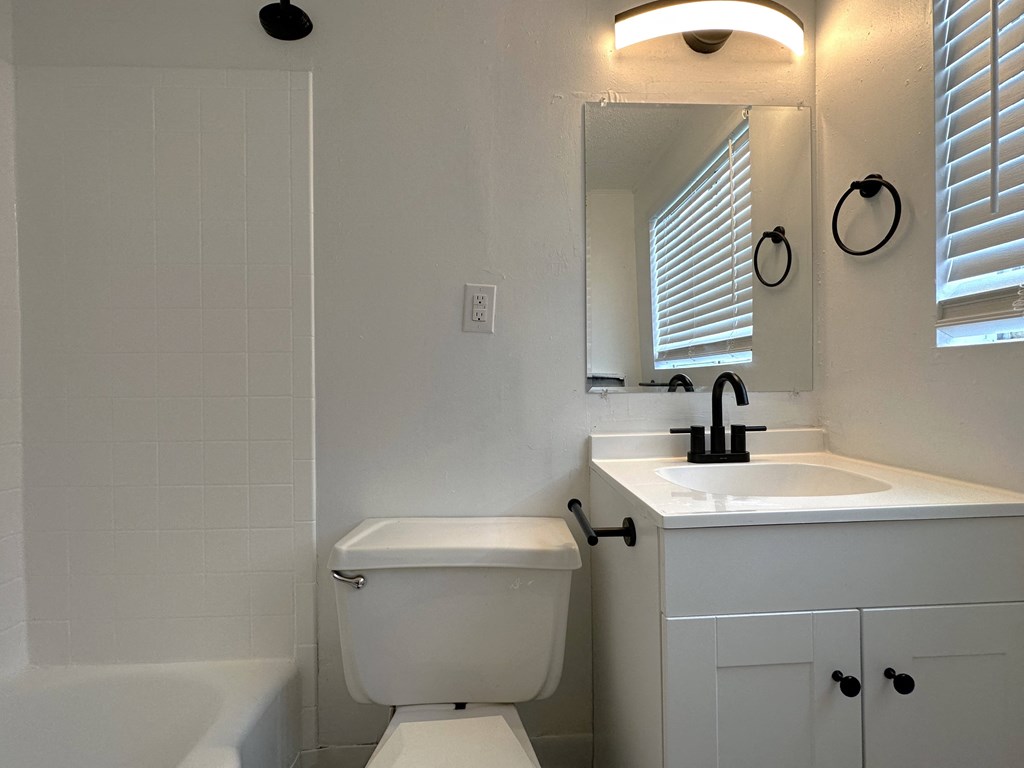 a small bathroom with a sink toilet and bathtub