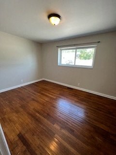 a room with a wooden floor and a window