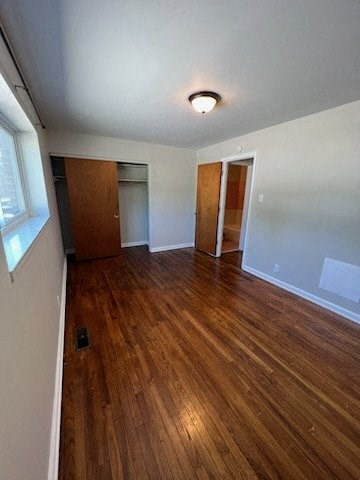 a room with a hard wood floor and a window
