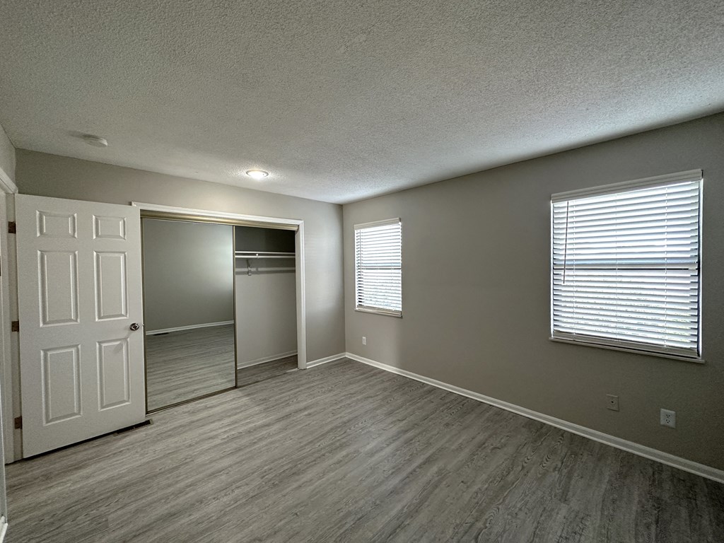 an empty living room with a large window
