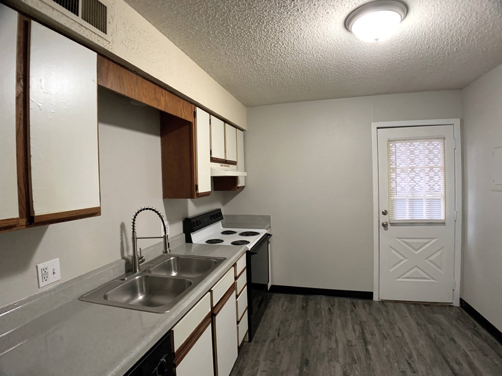 full kitchen with door and farm sink