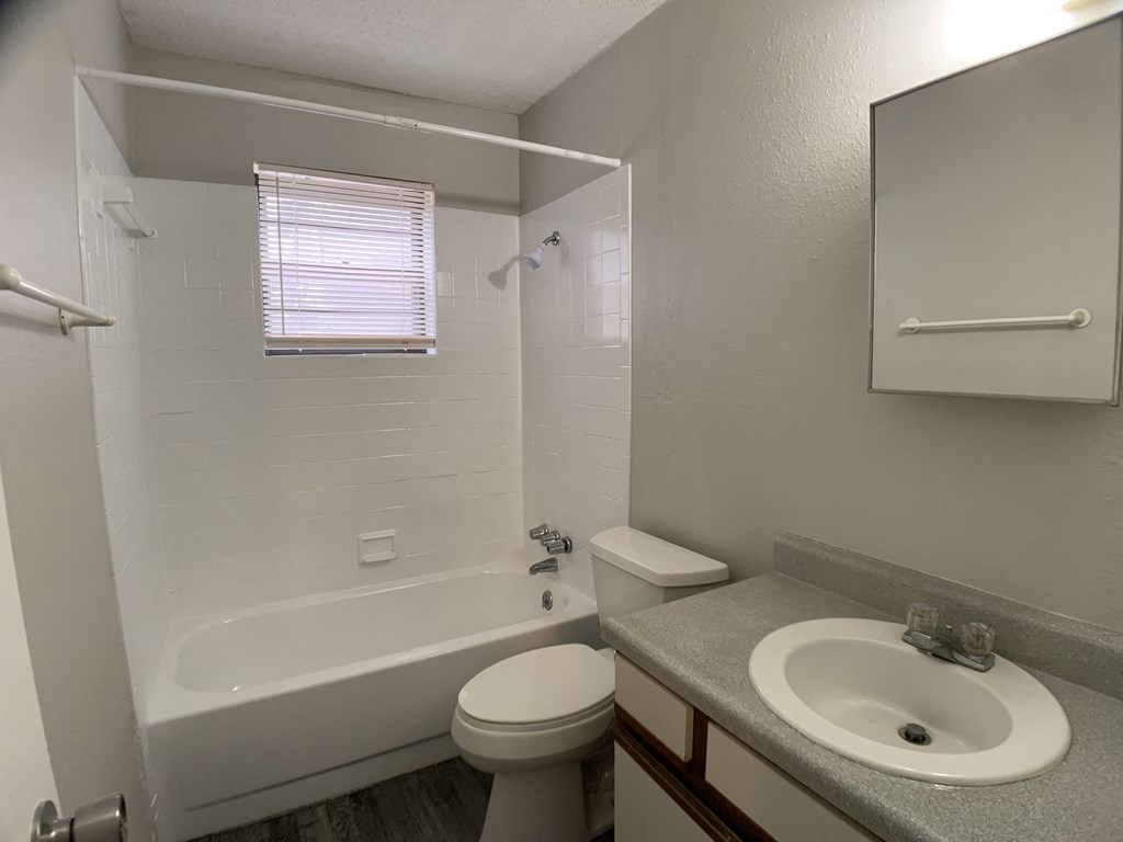 Full bath room with tub and tiling