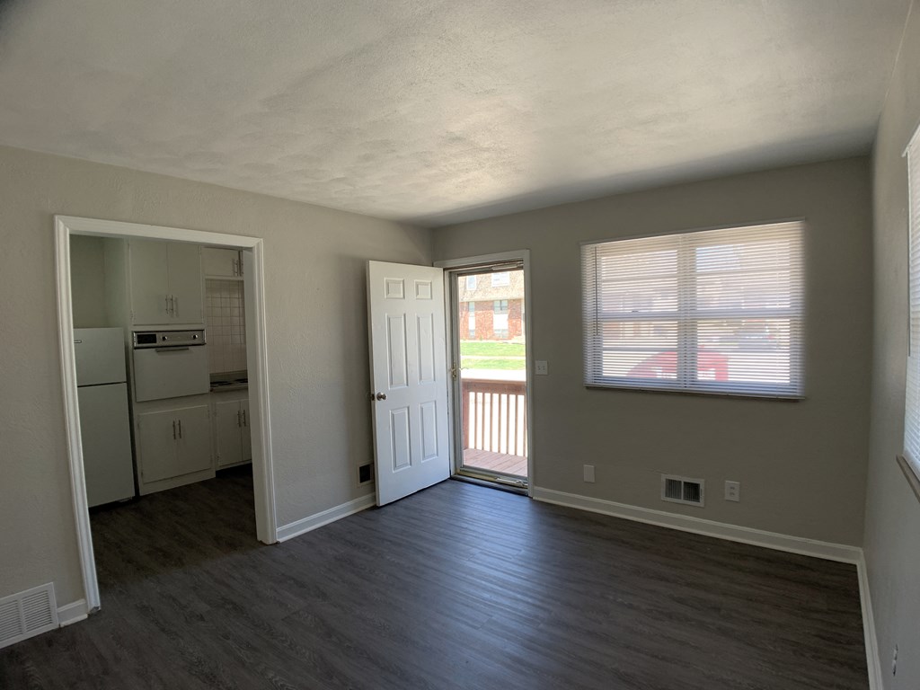 Spacious living room looking into kitchen