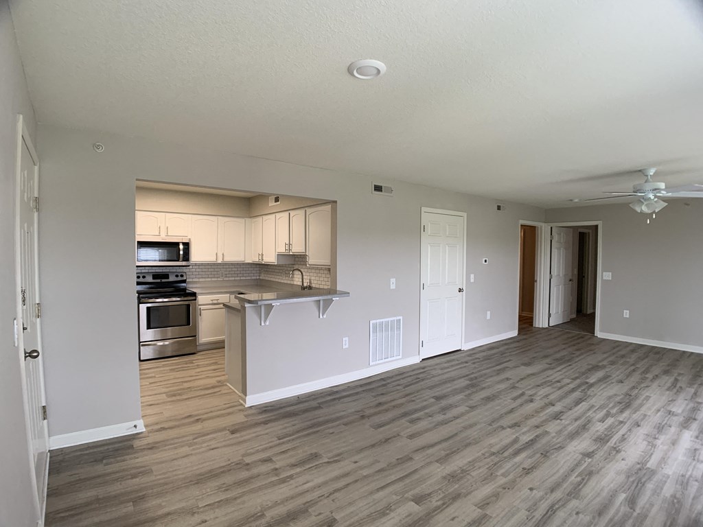 Living room leading into kitchen at Saddlewood in Olathe, KS