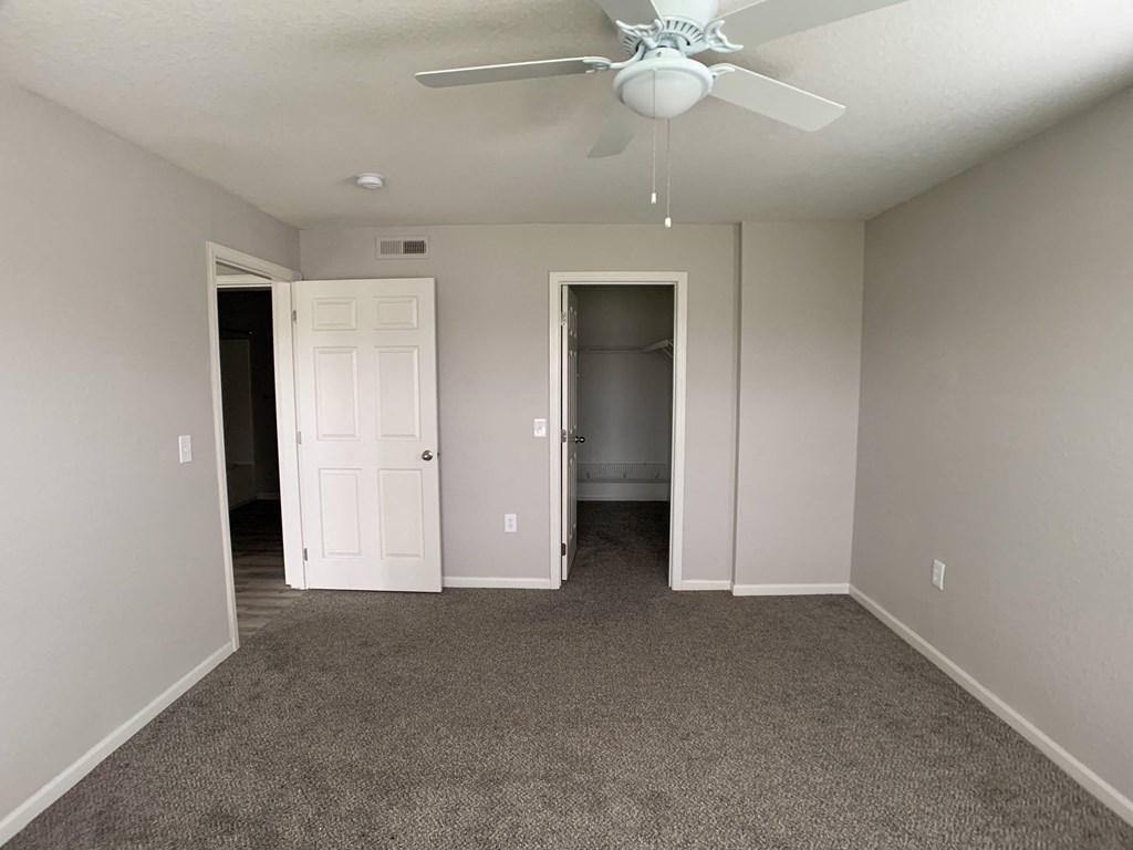 Bedroom with closet and ceiling fan at Saddlewood in Olathe, KS