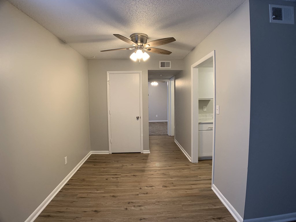 hardwood floor with dining area and ceiling fan