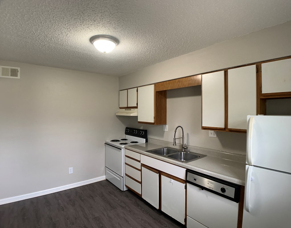 Full kitchen with spacious cabinetry and white appliances