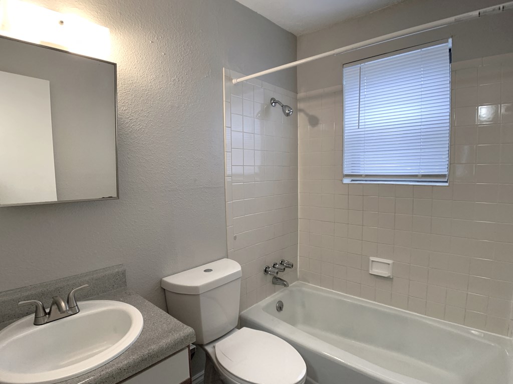 Full bathroom with tub and tiling