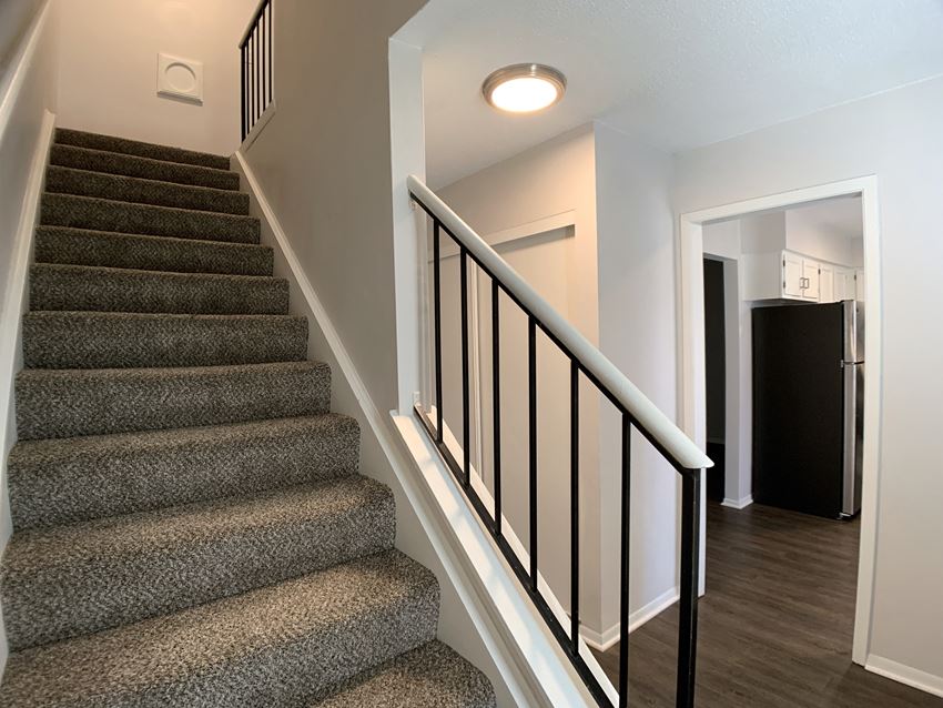 Carpeted stairs looking over into the kitchen - Photo Gallery 1