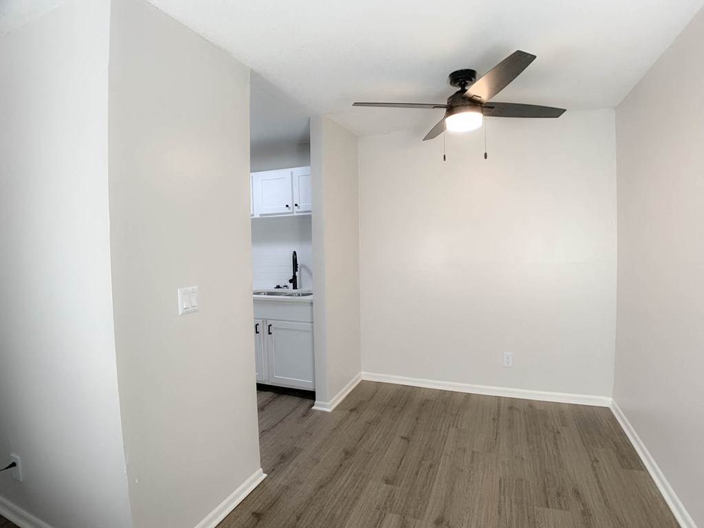Photo of living area with ceiling fan, vinyl flooring and view of kitchen in Kansas City.