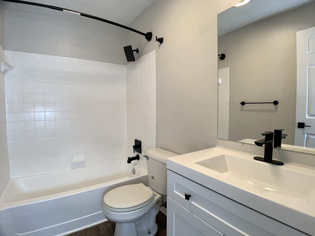 Photo of full sized bathroom with white countertops and bathtub in Kansas City.