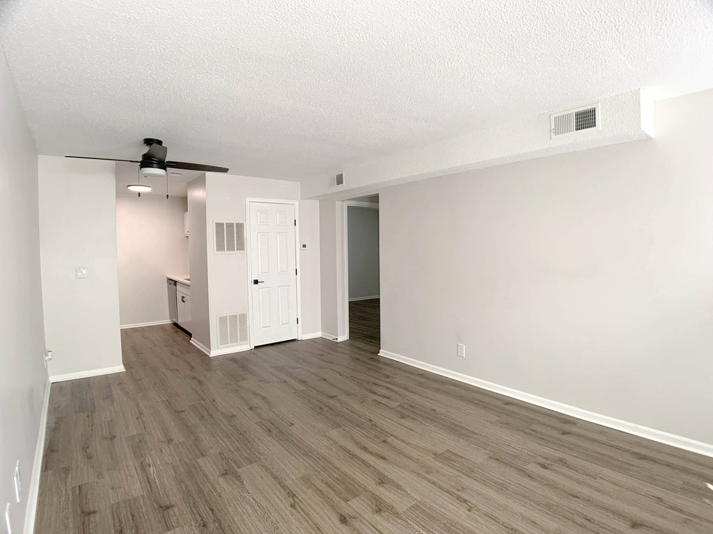 Photo of apartment with vinyl flooring and view of kitchen and hallway in Kansas City.