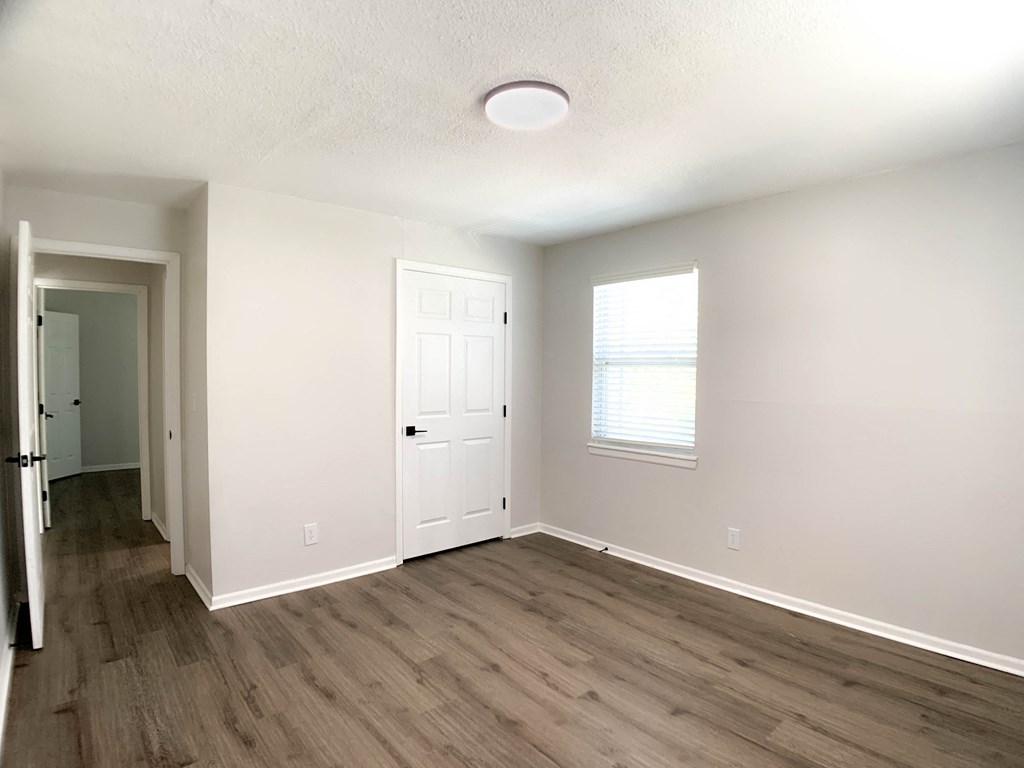 Photo of apartment with vinyl flooring and view of kitchen and hallway in Kansas City.